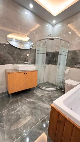 a bathroom with a shower and a sink and a tub at Taksim Istiklal Street Next2 Hotel in Istanbul