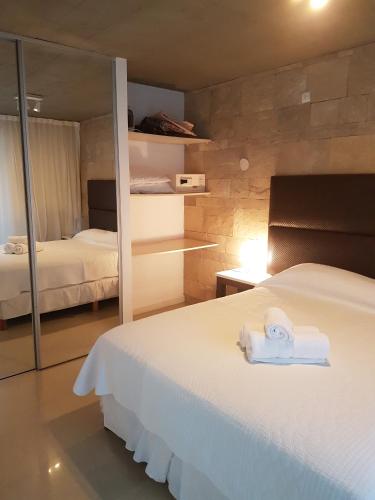 a bedroom with a bed with towels on it at Linda Bay Resort Apt 302 in Mar de las Pampas