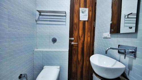 a bathroom with a toilet and a sink at hotel chandigarh pavilion in Chandīgarh