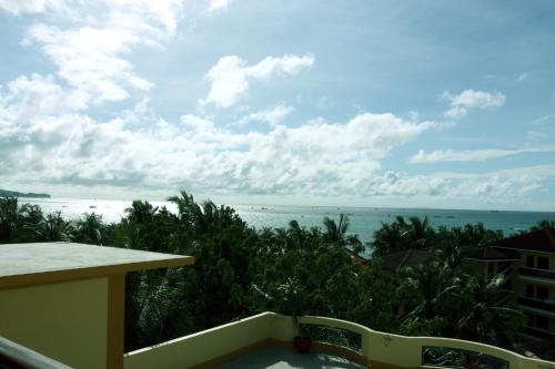 a view of the ocean from the balcony of a resort at Paradise Garden Hotel and Convention Center Boracay Powered by ASTON in Boracay