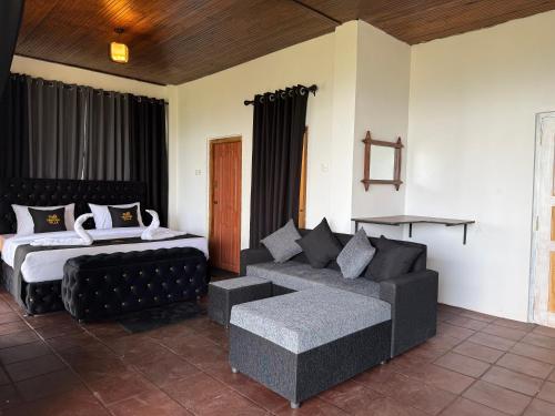 a living room with a couch and a bed at Eden Heaven Villa in Nuwara Eliya