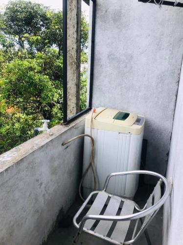 a chair sitting next to a window next to a heater at Bevibe kottawa in Kottawa