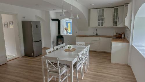 a kitchen and dining room with a table and chairs at Pod Borovicí Broumy in Broumy