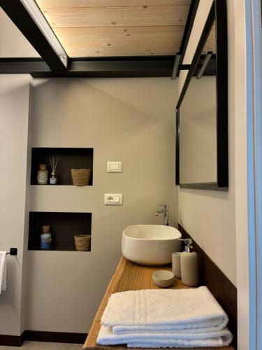a bathroom with a white sink and a tub at Lungamerenda in Costigliole dʼAsti