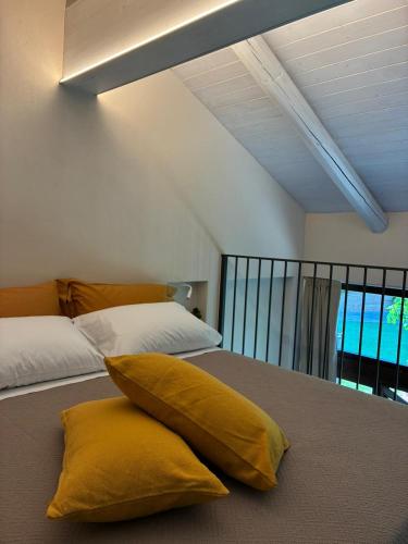 a yellow pillow sitting on a bed in a room at Lungamerenda in Costigliole dʼAsti