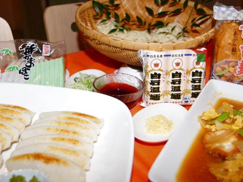a table with plates of food and a bowl of soup at Hotel Green Selec in Sendai
