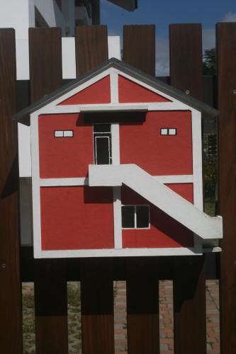 a painting of a red barn on a fence at Bella Casa B&B in Longtian