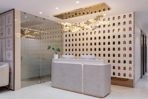 a bathroom with a sink and a mirror at Hotel Lohara Inn in Chandrapur