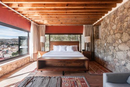 A bed or beds in a room at Casa del Rector Hotel Boutique