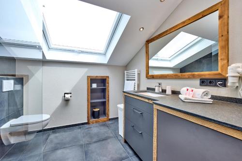 a bathroom with a sink and a mirror at Föhrenhof Apartments in Farchant