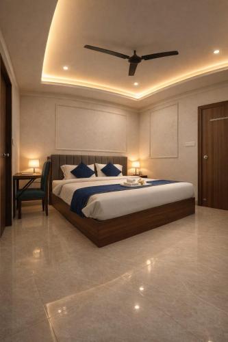 a bedroom with a large bed with a ceiling at Accuotel Inn RG Grand in Kanāria