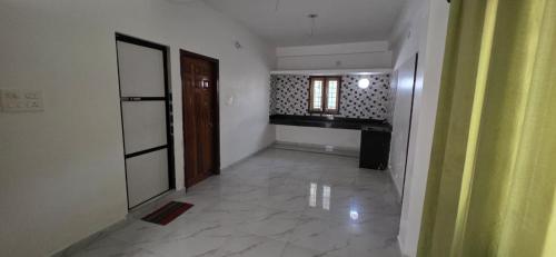 an empty room with a hallway with a door and a window at Hottel! Basera in Bhubaneshwar