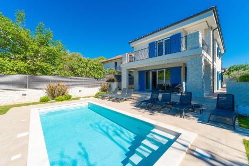 a villa with a swimming pool and a house at Modern Villa with Pool and Wellness in Sveti Vid-Miholjice