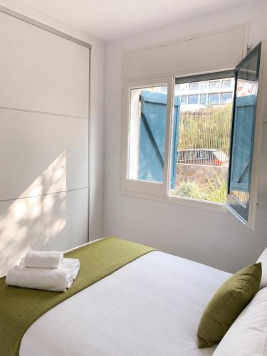 a bedroom with a bed and a window at VILLA PARADISE SILVIA in Sant Pere de Ribes