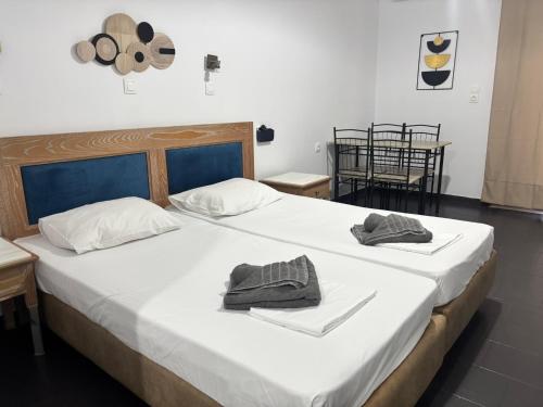 a bedroom with a large bed with two towels on it at Aleka Apartments in Kos