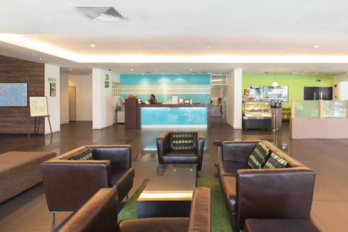 a lobby with couches and chairs in a hospital at The LimeTree Hotel, Kuching in Kuching