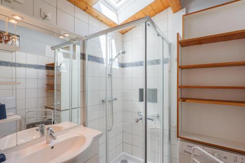 a bathroom with a glass shower and a sink at Gite Du Mouredon in Vallon-Pont-dʼArc