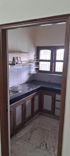 a kitchen with a sink and a counter top at Sewa Kunj in Mussoorie