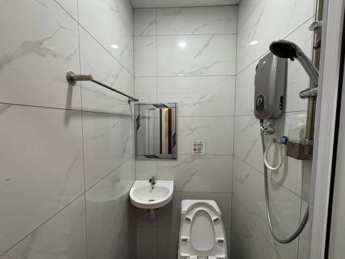 a small bathroom with a toilet and a sink at Collection O Near Sunway Karnival Mall Formerly Rest Haven in Bukit Mertajam