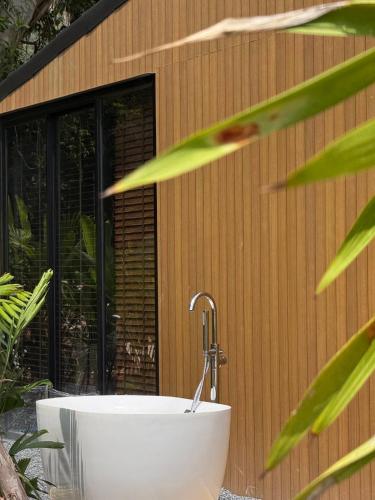 a bath tub sitting in front of a building at Wave & Vibes Koh chang in Ban Chek Bae (1)