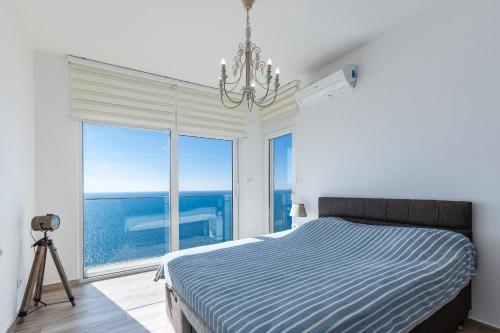 a bedroom with a bed and a large window at Your Home Montenegro in Dobra Voda