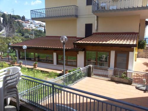 a balcony of a building with a white chair at villa marta in Formia