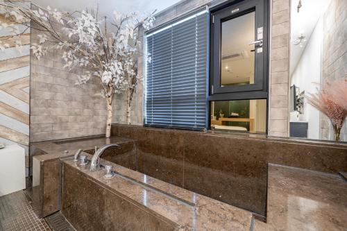 a bathroom with a sink and a window at Hotel Lassa in Seoul