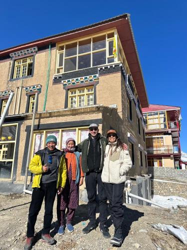 a group of people standing in front of a building at Piti khangpa in Kaza