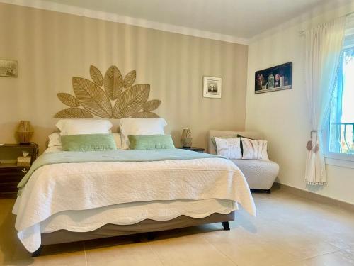 a bedroom with a large bed and a couch at La maison de la Cigale in Forcalqueiret