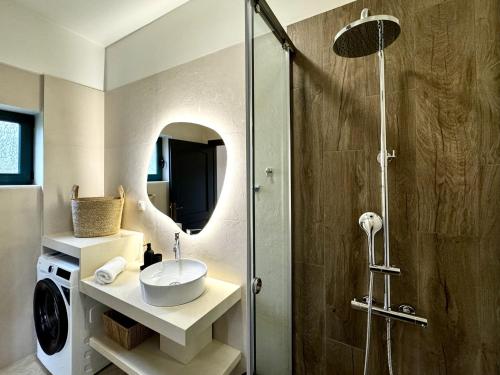 a bathroom with a sink and a shower at Villa Nynemia Almyrida Crete in Plaka