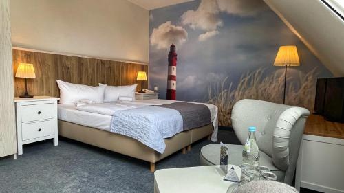 a bedroom with a bed and a lighthouse painting on the wall at Hotel & Restaurant Seebrücke in Zingst