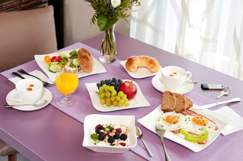 a purple table topped with breakfast foods and drinks at Hotel Birkenhof in Bad Radkersburg