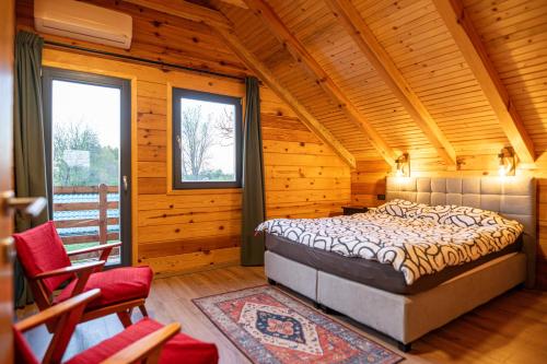 a bedroom with a bed in a wooden house at Lika View house in Gospić