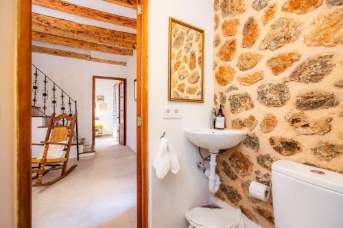 a bathroom with a toilet and a sink at Ca Sa Padrina Banyalbufar in Banyalbufar