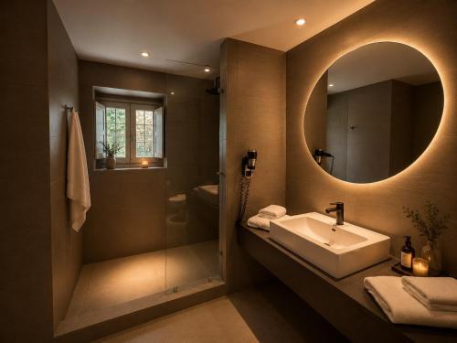 a bathroom with a sink and a mirror at Monopatia Resort in Ano Pedina