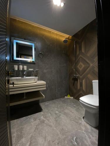 a bathroom with a sink and a toilet at Sky square murree in Murree