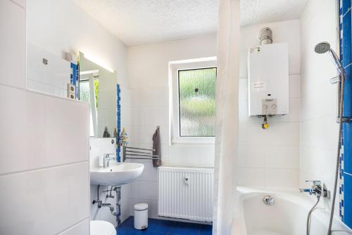 a white bathroom with a sink and a toilet at Über den Dächern in Cochem Altstadt in Cochem