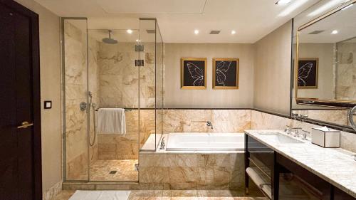 a large bathroom with a tub and a shower at THE LIN Hotel in Taichung