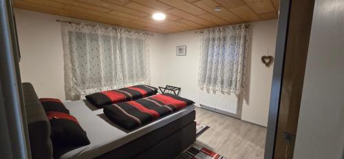 a bedroom with a bed with two pillows on it at Ferienwohnung Rettersheim Mainspessart in Rettersheim