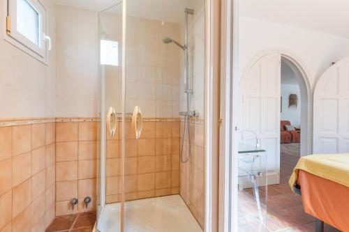 a shower with a glass door in a bathroom at Villa Sol del Este, Es Castell in Es Castell