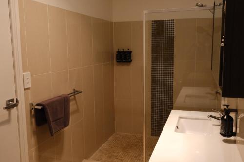 a bathroom with a sink and a shower at Cobar Central Motor Inn in Cobar