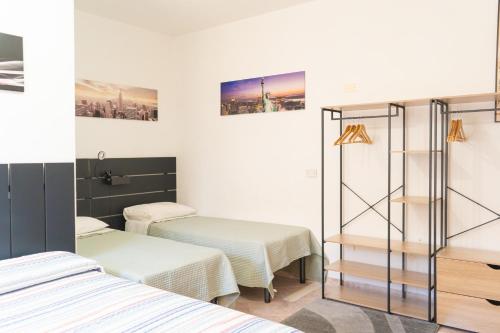 a hospital room with two beds and a mirror at Il Pepe Rosa in Posada