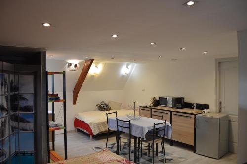 a room with a kitchen and a table with chairs at Chez Pierrette in Pont-Croix