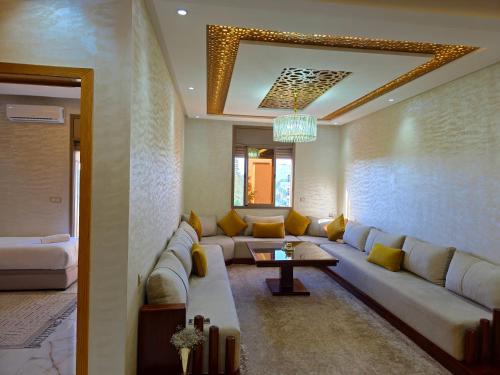 a living room with a couch and a table at Azur Apartment essaouira in Essaouira