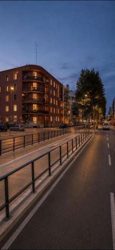 an empty city street with a building in the background at VK Rooms in Bari