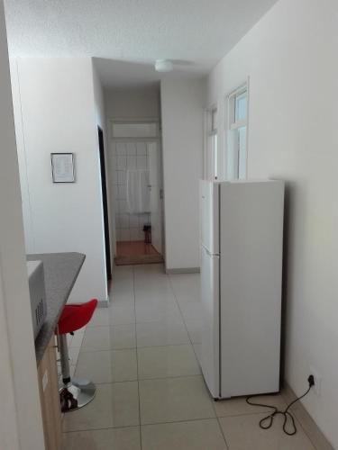 a kitchen with a refrigerator in the middle of a room at Home Inn Self-Catering in Windhoek