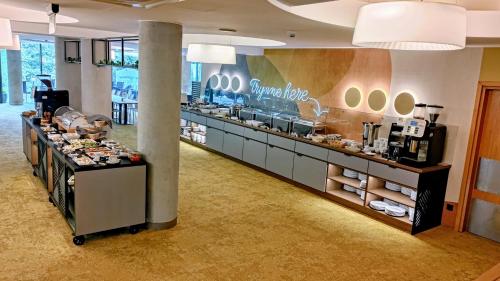 a store with a counter with food on it at Hotel HP Park in Olsztyn