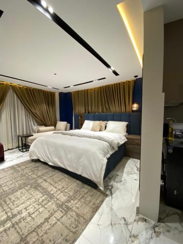 a bedroom with a large bed with marble floors at Sky square murree in Murree
