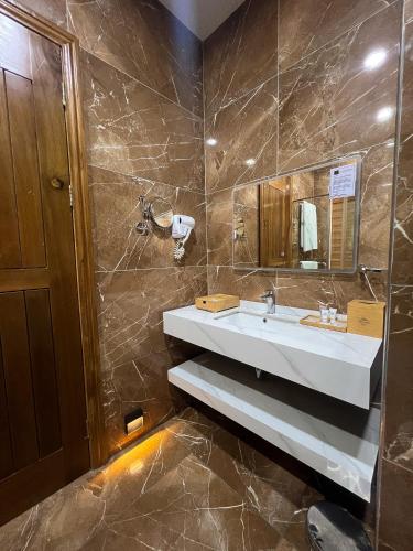 a bathroom with a sink and a mirror at Vintano Hotel in Lagos