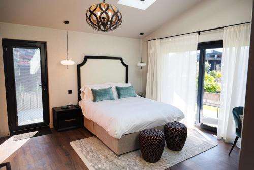 a bedroom with a bed and two windows at Retreat 10 in Beccles